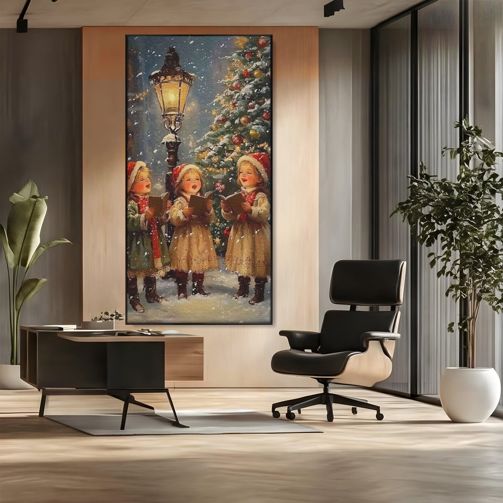 Tablou canvas cu pictura cu trei fetite colindatoare, in rama de aluminiu negru, pe perete intr-un birou